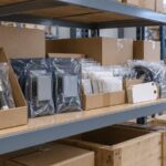 Concept illustration of packaged transformer accessories and inventory tags on a warehouse shelf